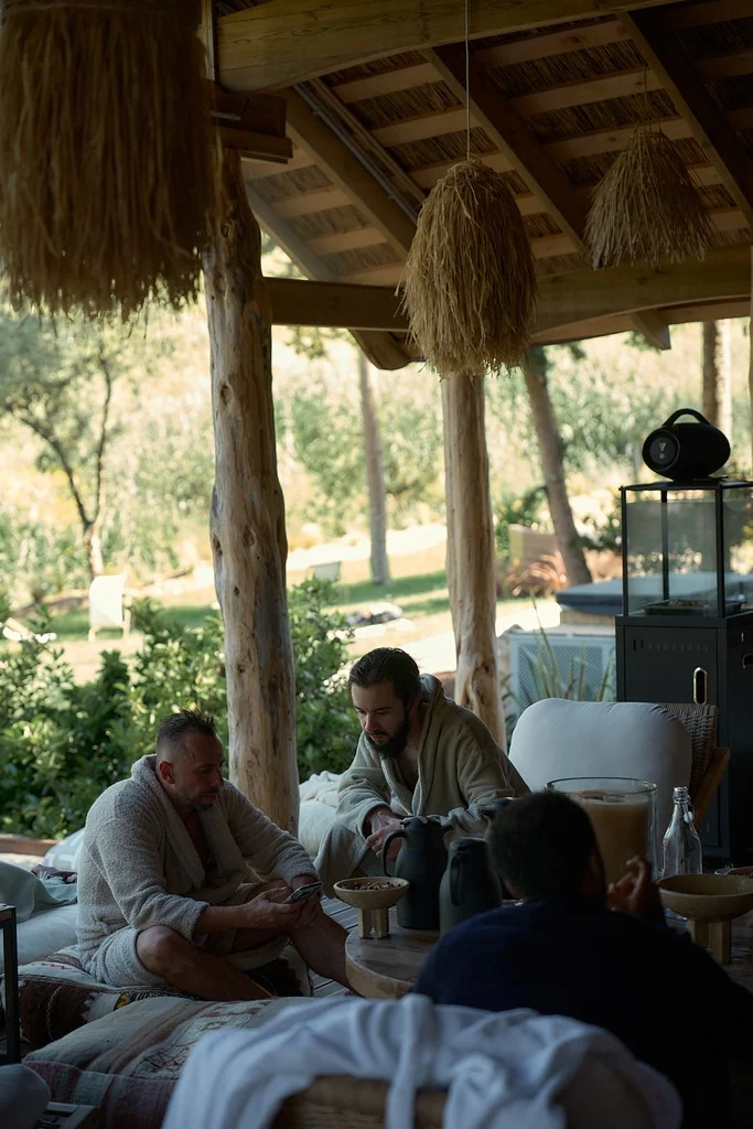 Guests in robes sharing tea in the open-sided ATMOS lounge