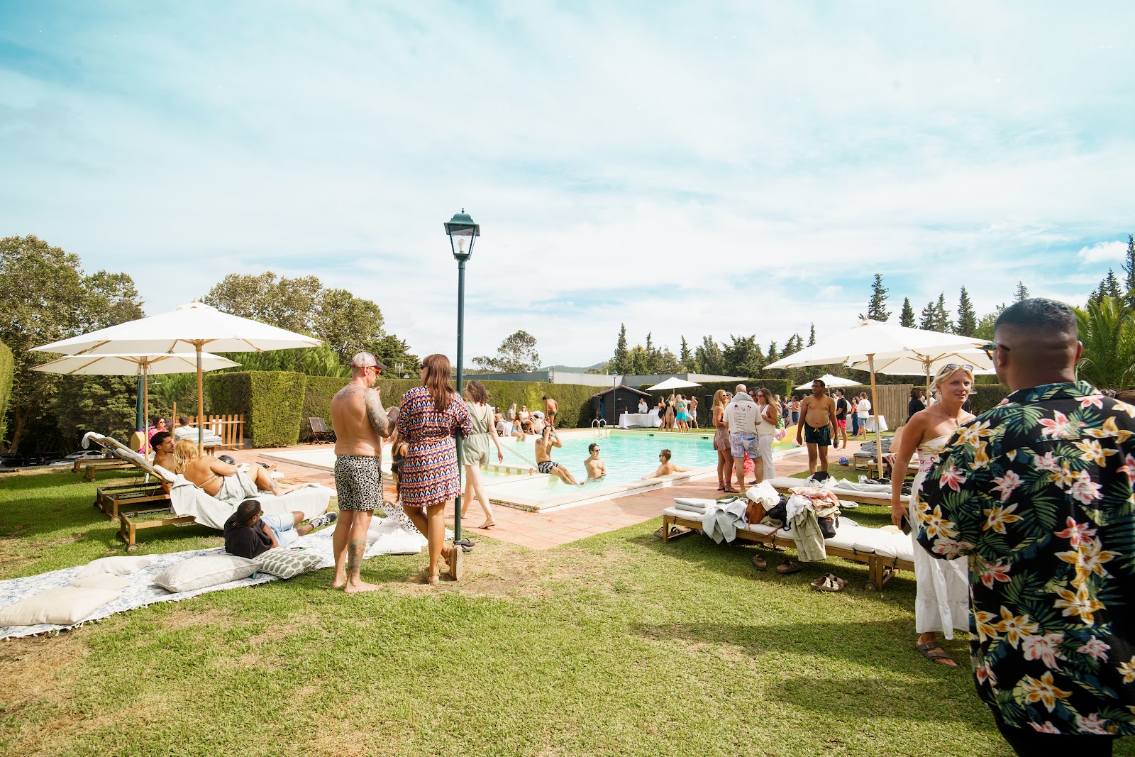Guests relaxing around the outdoor pool and pool bar at DOMA