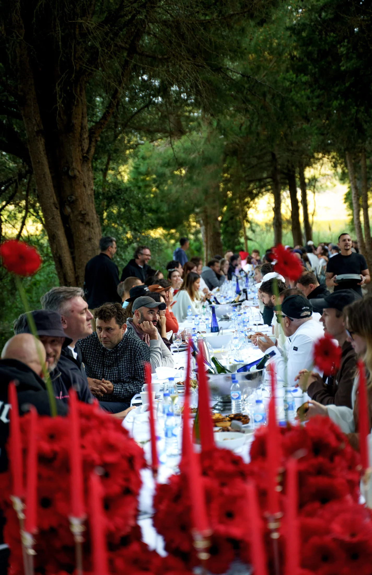 Founders sharing a long-table meal beneath the pines at Founders for Founders at DOMA
