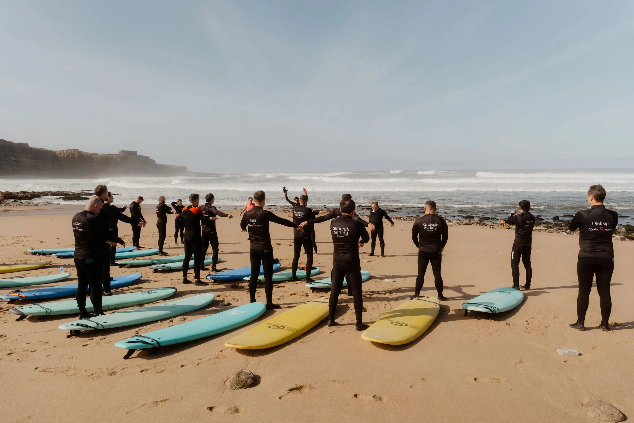 Strategic Surfing participants practising with instructors and boards on the Ericeira coast